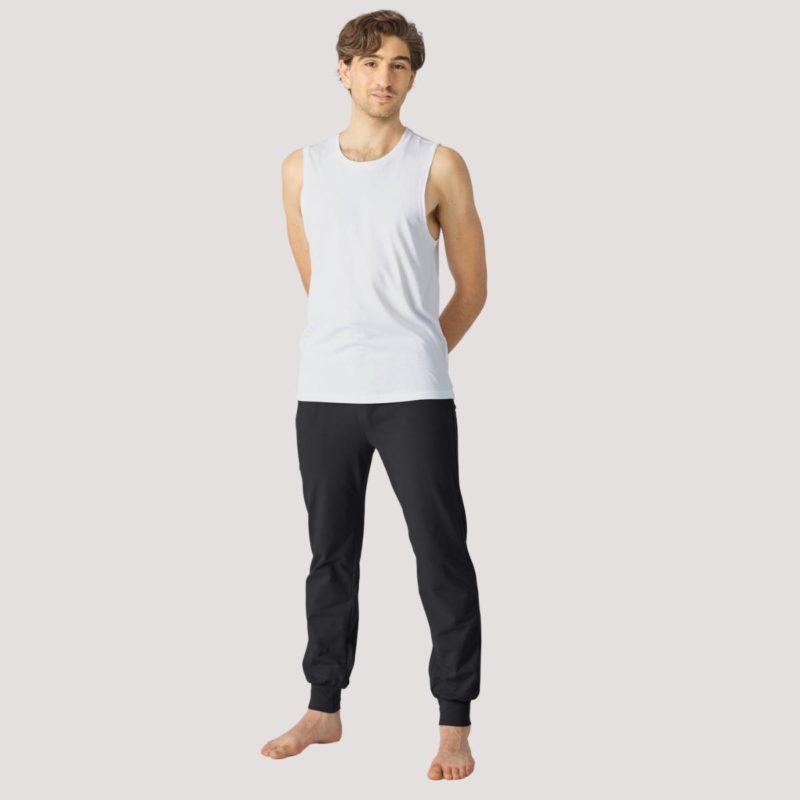 Mann im Yoga Outfit mit weißem Top und schwarzer Yoga Hose von Lotuscrafts